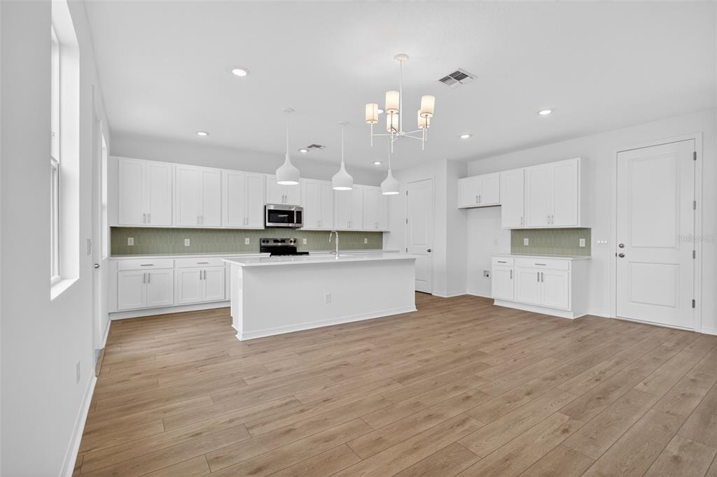 5765 Haystack Drive St. Cloud, FL 34771 - Photo 11 of 42 a view of kitchen with kitchen island sink stainless steel appliances and cabinets