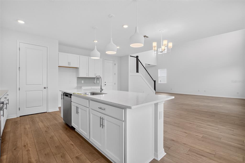 5765 Haystack Drive St. Cloud, FL 34771 - Photo 16 of 42 a kitchen with a sink and wooden floor