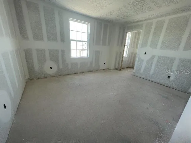 an empty room with closet and mirror