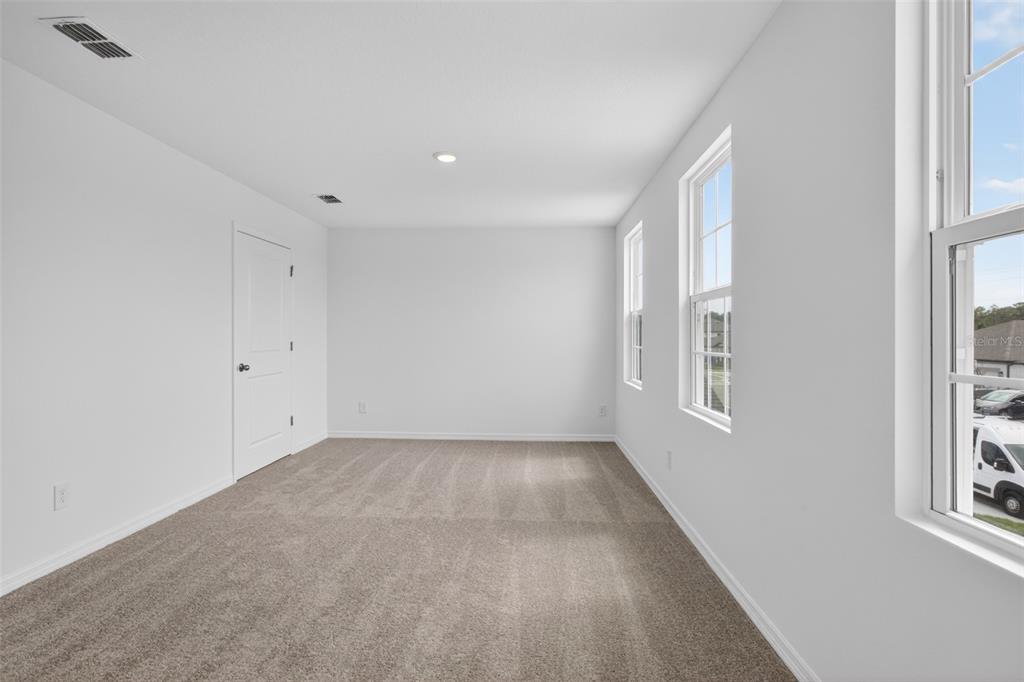 5765 Haystack Drive St. Cloud, FL 34771 - Photo 25 of 42 an empty room with windows