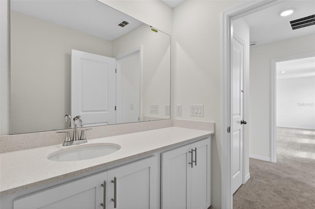 5765 Haystack Drive St. Cloud, FL 34771 - Photo 28 of 42 a bathroom with a sink and a mirror