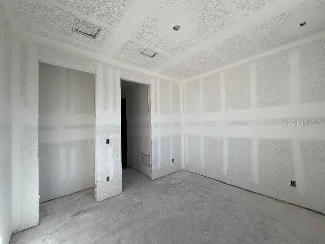 a view of a room with rack on the wall and a window