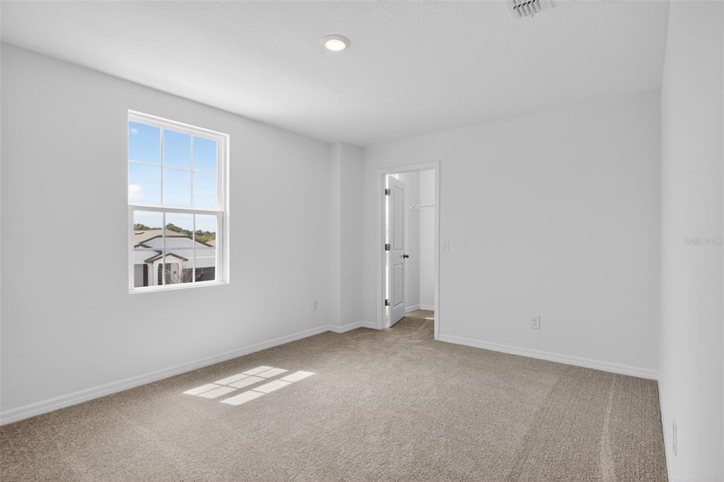 5765 Haystack Drive St. Cloud, FL 34771 - Photo 29 of 42 an empty room with windows