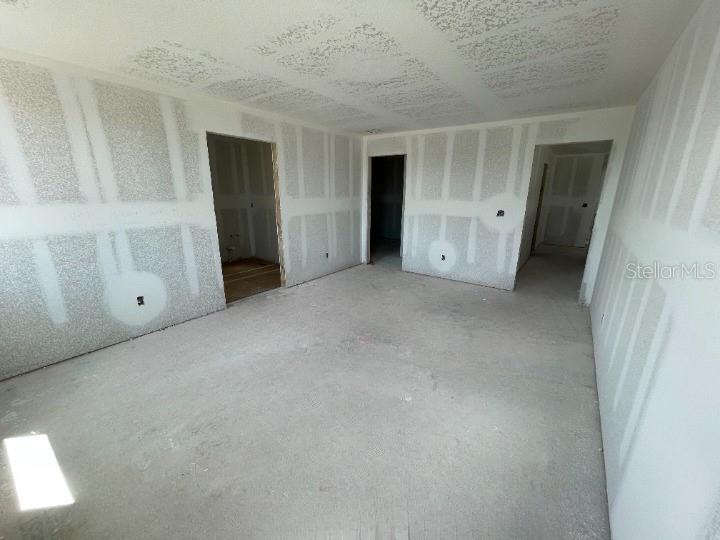 5765 Haystack Drive St. Cloud, FL 34771 - Photo 29 of 42 an empty room with closet and mirror