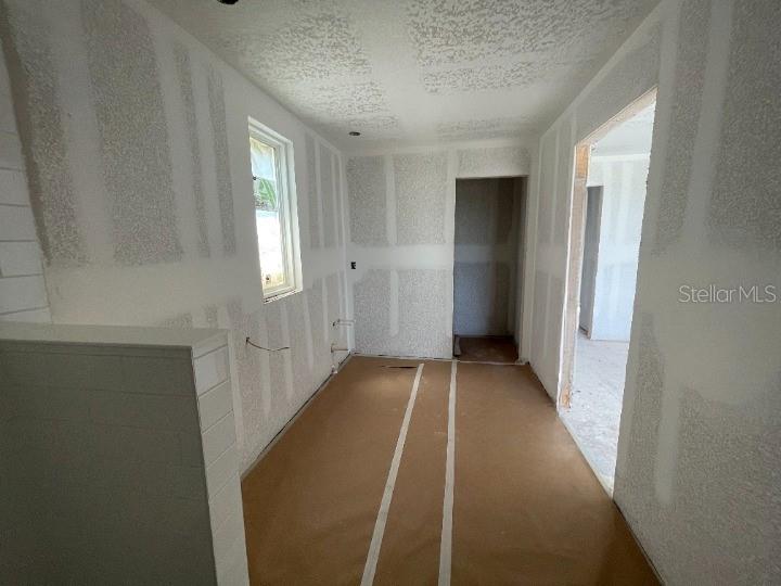 5765 Haystack Drive St. Cloud, FL 34771 - Photo 31 of 42 a view of a hallway with wooden floor and closet area