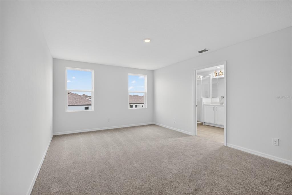 5765 Haystack Drive St. Cloud, FL 34771 - Photo 32 of 42 an empty room with windows and closet