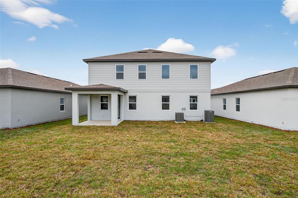 5765 Haystack Drive St. Cloud, FL 34771 - Photo 38 of 42 a view of a house with a backyard