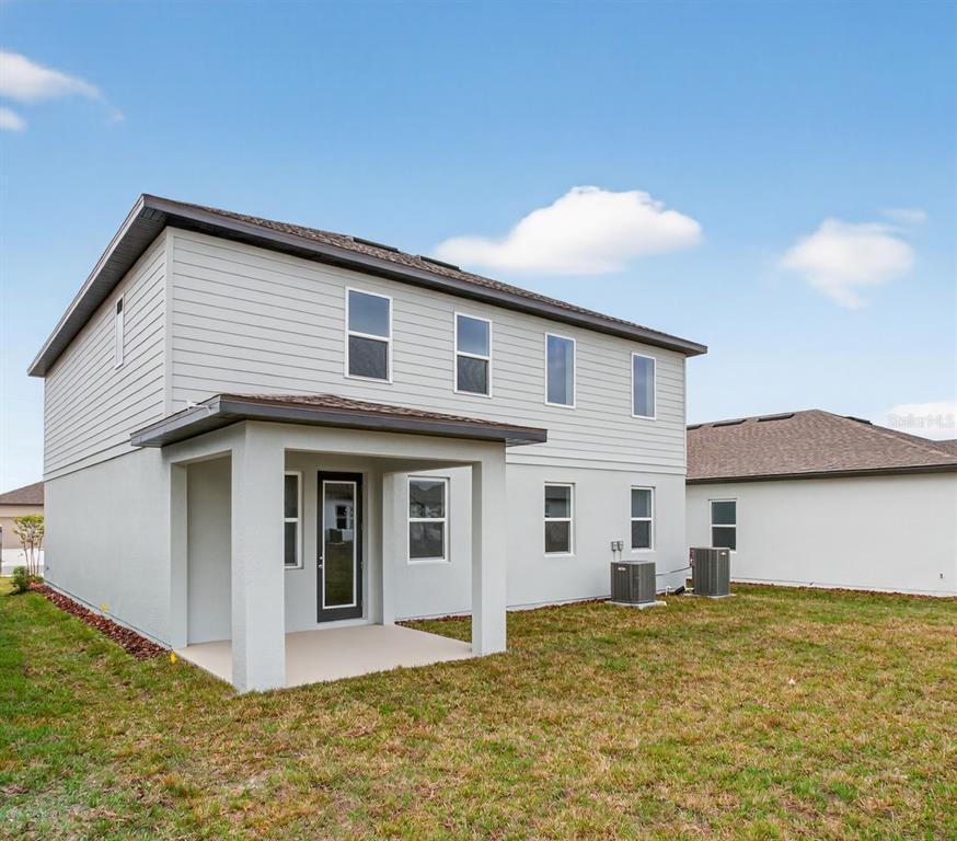 5765 Haystack Drive St. Cloud, FL 34771 - Photo 39 of 42 a view of a house with backyard and a garden