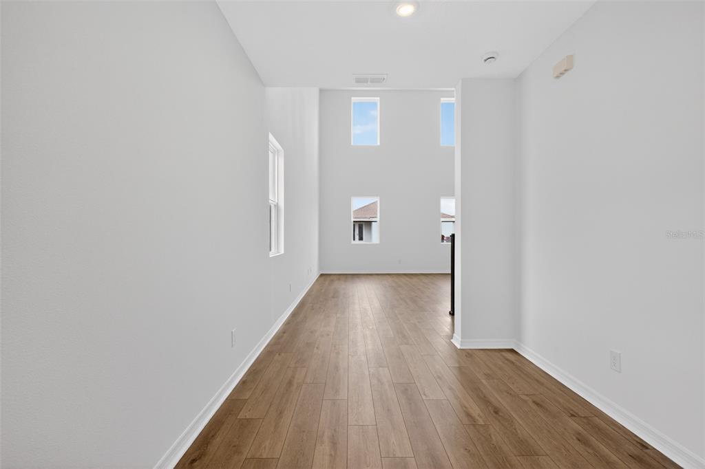 5765 Haystack Drive St. Cloud, FL 34771 - Photo 4 of 42 a view of hallway with wooden floor