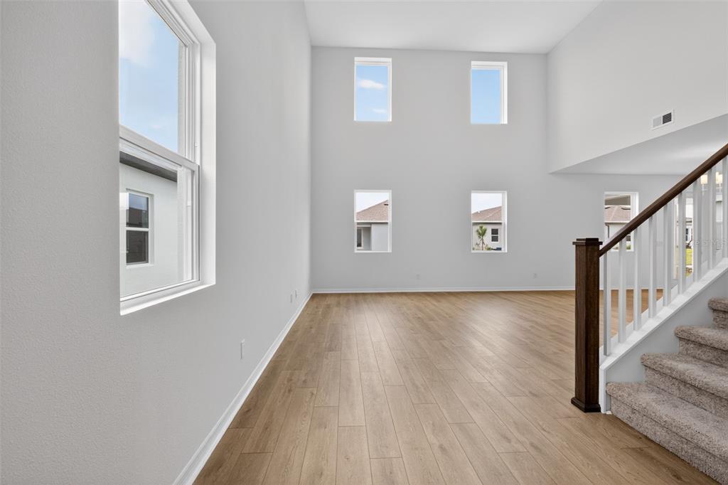 5765 Haystack Drive St. Cloud, FL 34771 - Photo 5 of 42 a view of an empty room with wooden floor and a window