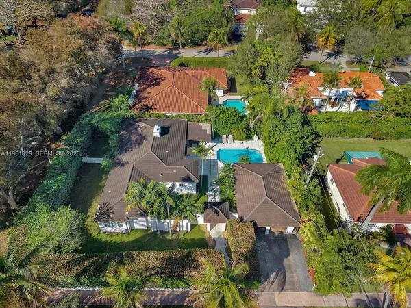 an aerial view of a house with a garden and lake view