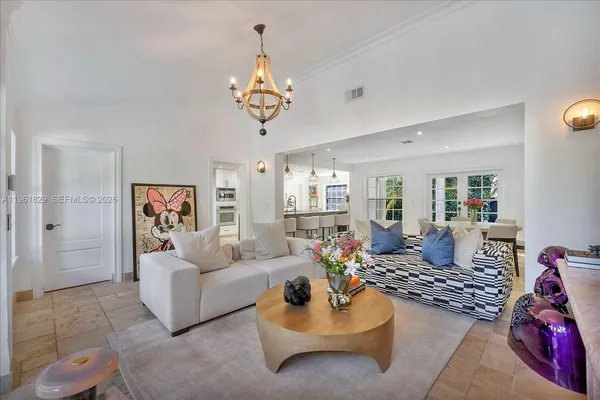 a living room with furniture or couch and a chandelier