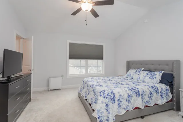 a bedroom with a bed and large window