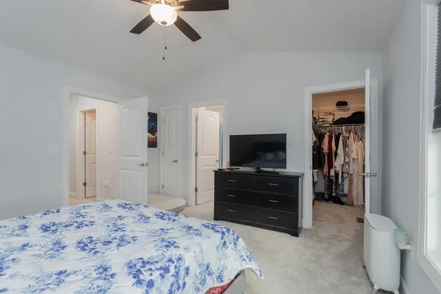 a bathroom with a toilet a sink a vanity and mirror