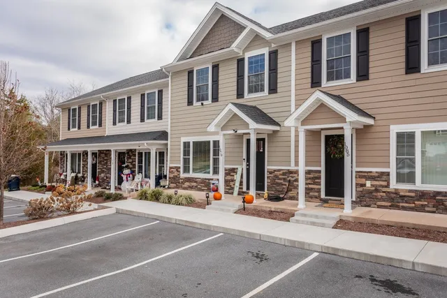 a view of a house with backyard and barbeque oven