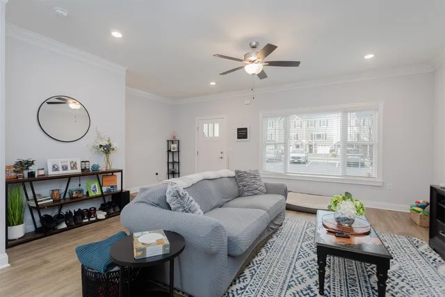 a living room with furniture and wooden floor