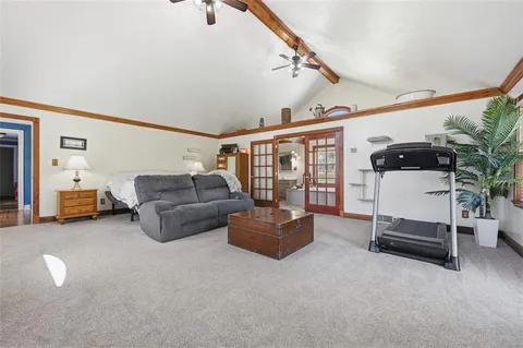 a living room with furniture and large windows