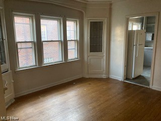1508 Genesee Road South Euclid, OH 44121 - Photo 6 of 12 Wood floored empty room featuring crown molding and a healthy amount of sunlight