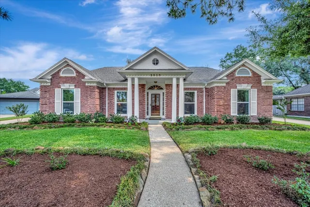 a front view of a house with yard