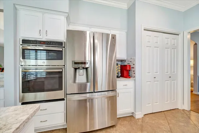 a kitchen with cabinets and stainless steel appliances