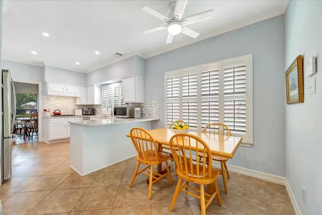 a view of a dining room with furniture and a chandelier