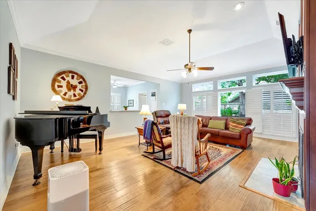 a living room with furniture a chandelier and a floor to ceiling window