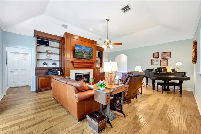 a living room with fireplace furniture and a wooden floor