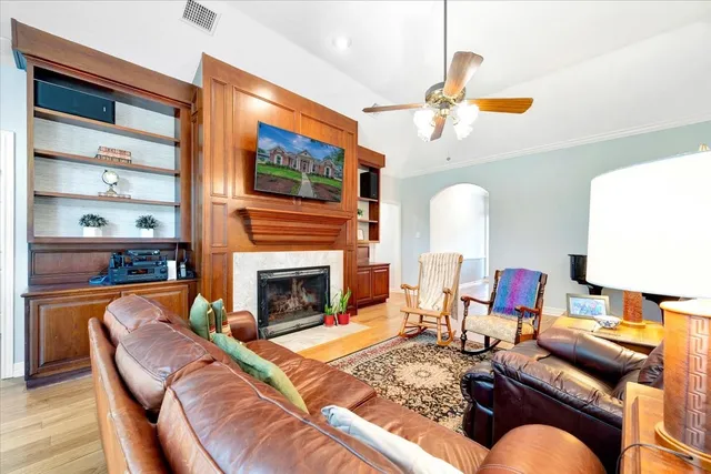 a living room with furniture fireplace and flat screen tv