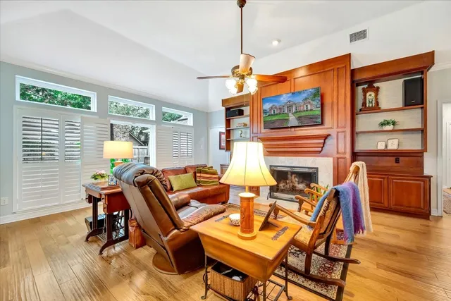 a living room with patio furniture and a wooden floor