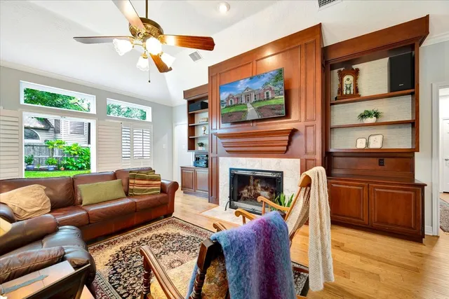 a living room with furniture a flat screen tv and a fireplace