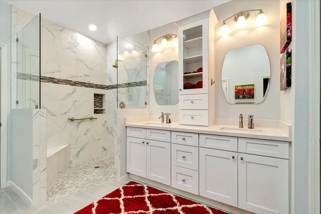 a bathroom with a sink a mirror and a shower