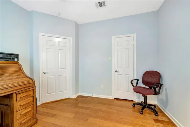 a view of a workspace with furniture and wooden floor