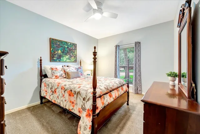 a bed sitting in a bedroom next to a window