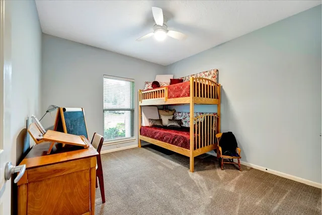 a bedroom with bed and a chandelier
