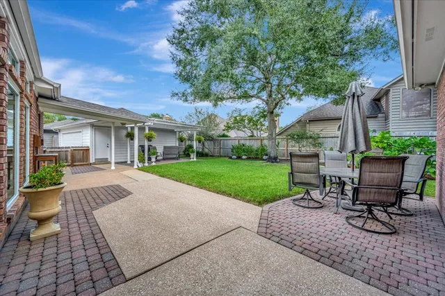 a view of a backyard with sitting area and garden