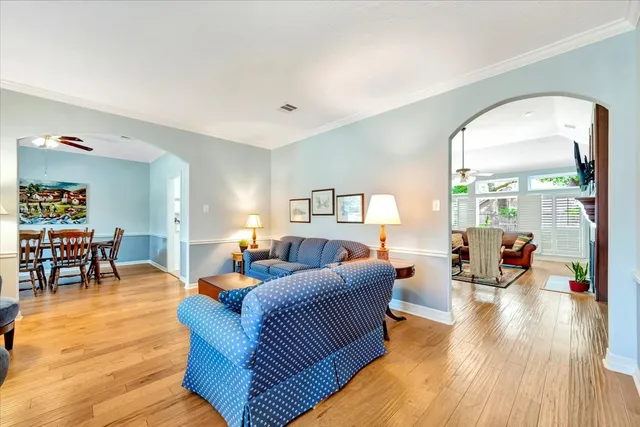 a living room with furniture and wooden floor