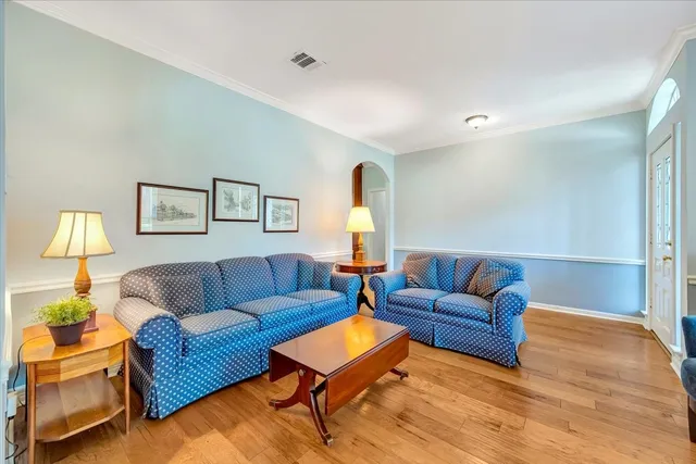 a living room with furniture and a lamp