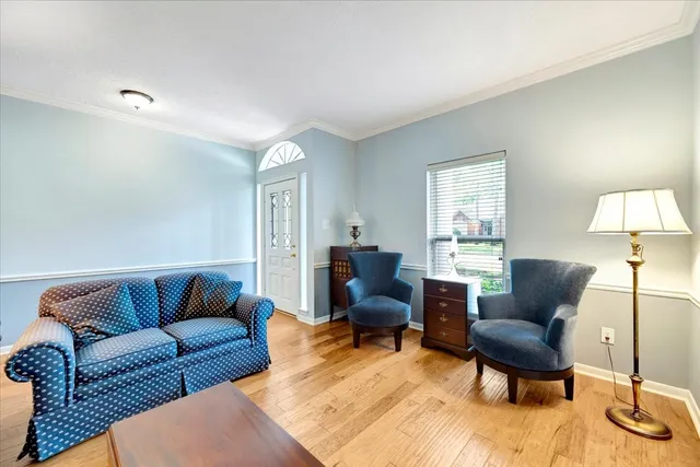a living room with furniture and a lamp