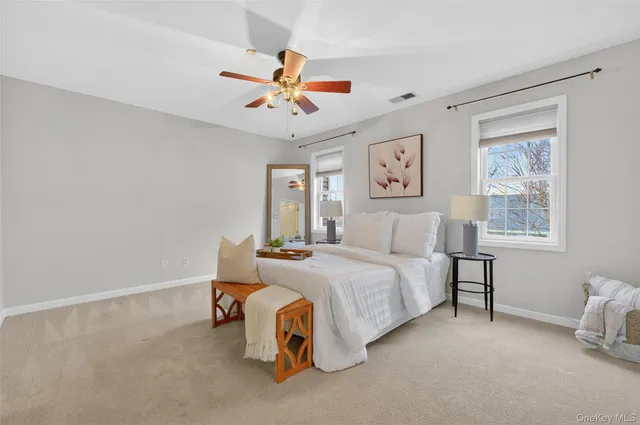 a spacious bedroom with a bed and a chandelier