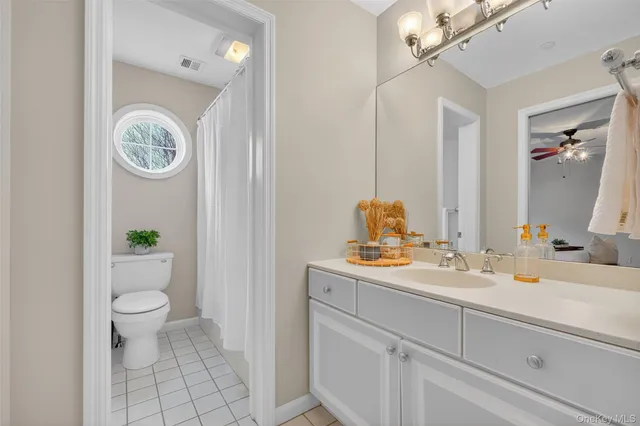 a bathroom with a toilet a sink and a mirror