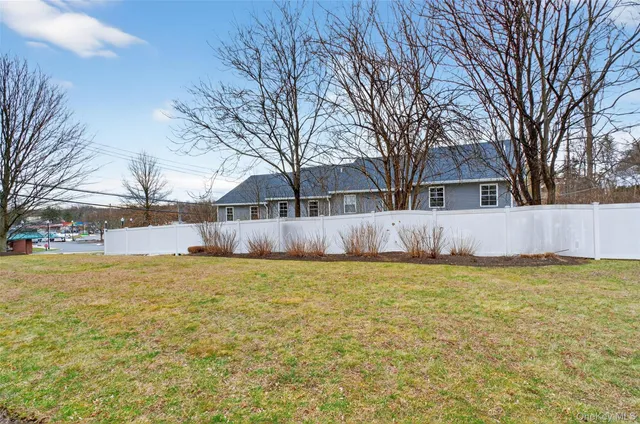 a front view of house with yard and trees