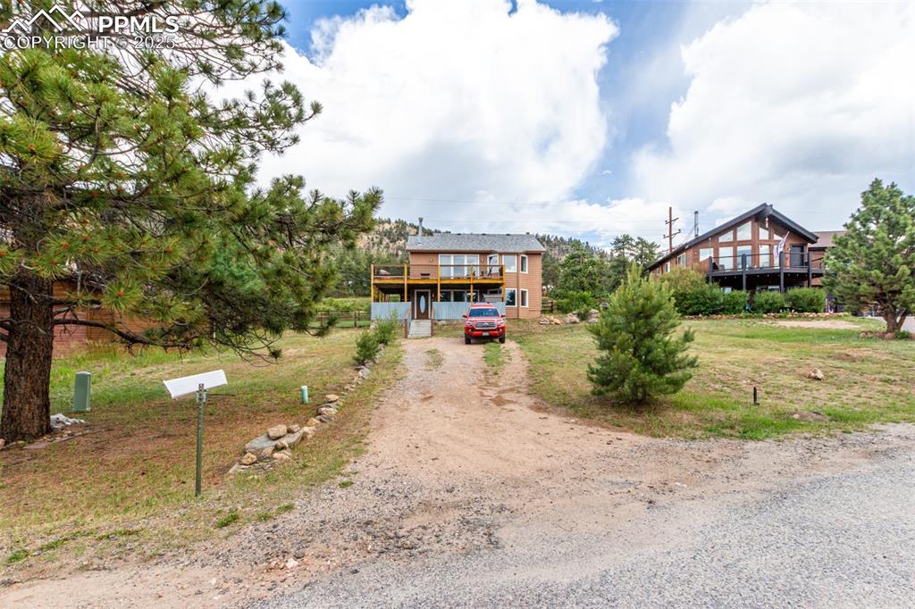 73 Sunlight Lane Bailey, CO 80421 - Photo 27 of 33 View of front of house featuring dirt driveway and a deck