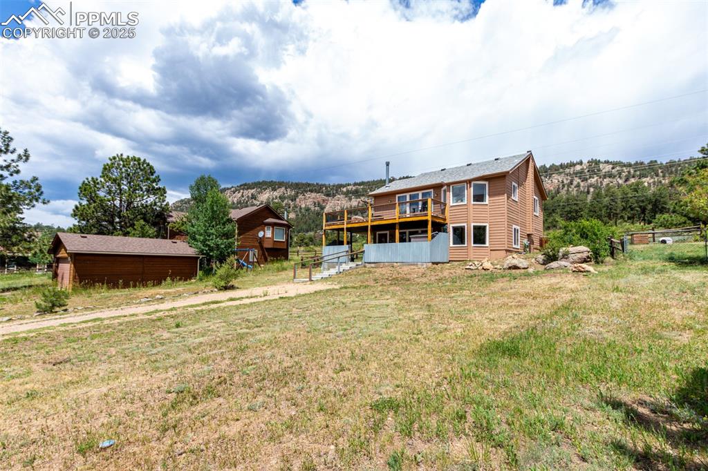 73 Sunlight Lane Bailey, CO 80421 - Photo 30 of 33 Rear view of house with a deck and a yard