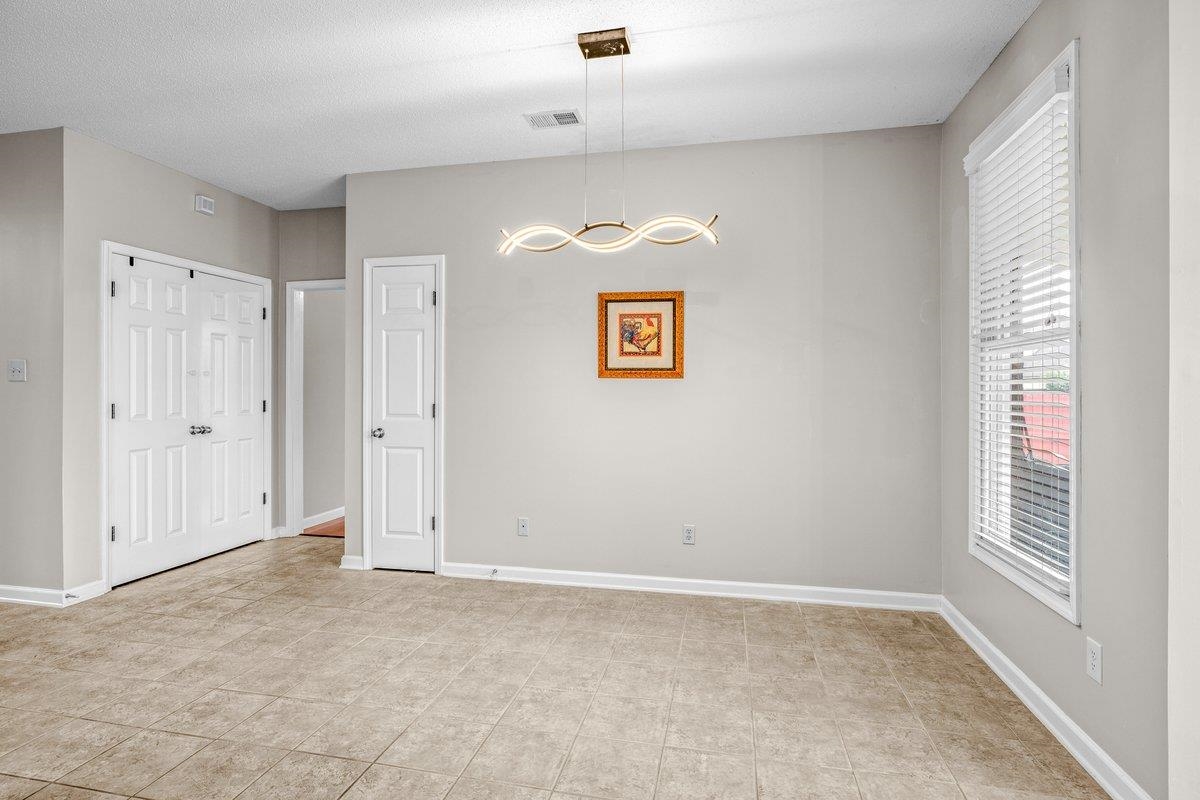 4840 Rainy Pass Road Collierville, TN 38017 - Photo 21 of 30 Spacious room featuring neutral wall tones, large format tile flooring, a contemporary linear light fixture, a window with horizontal blinds, and paneled doors