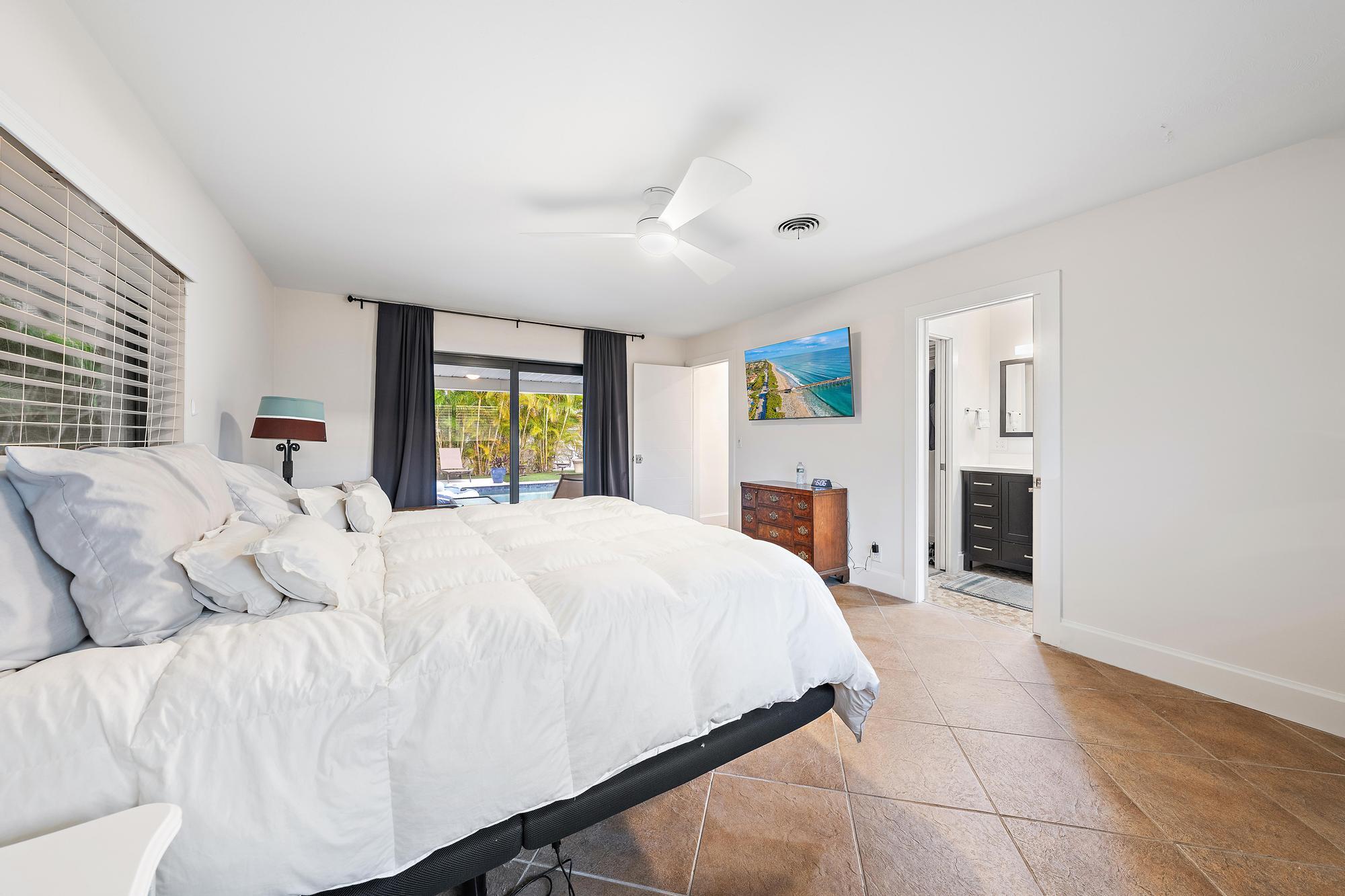 1120 Singer Drive Riviera Beach, FL 33404 - Photo 13 of 37 a bed room with a bed and a tv