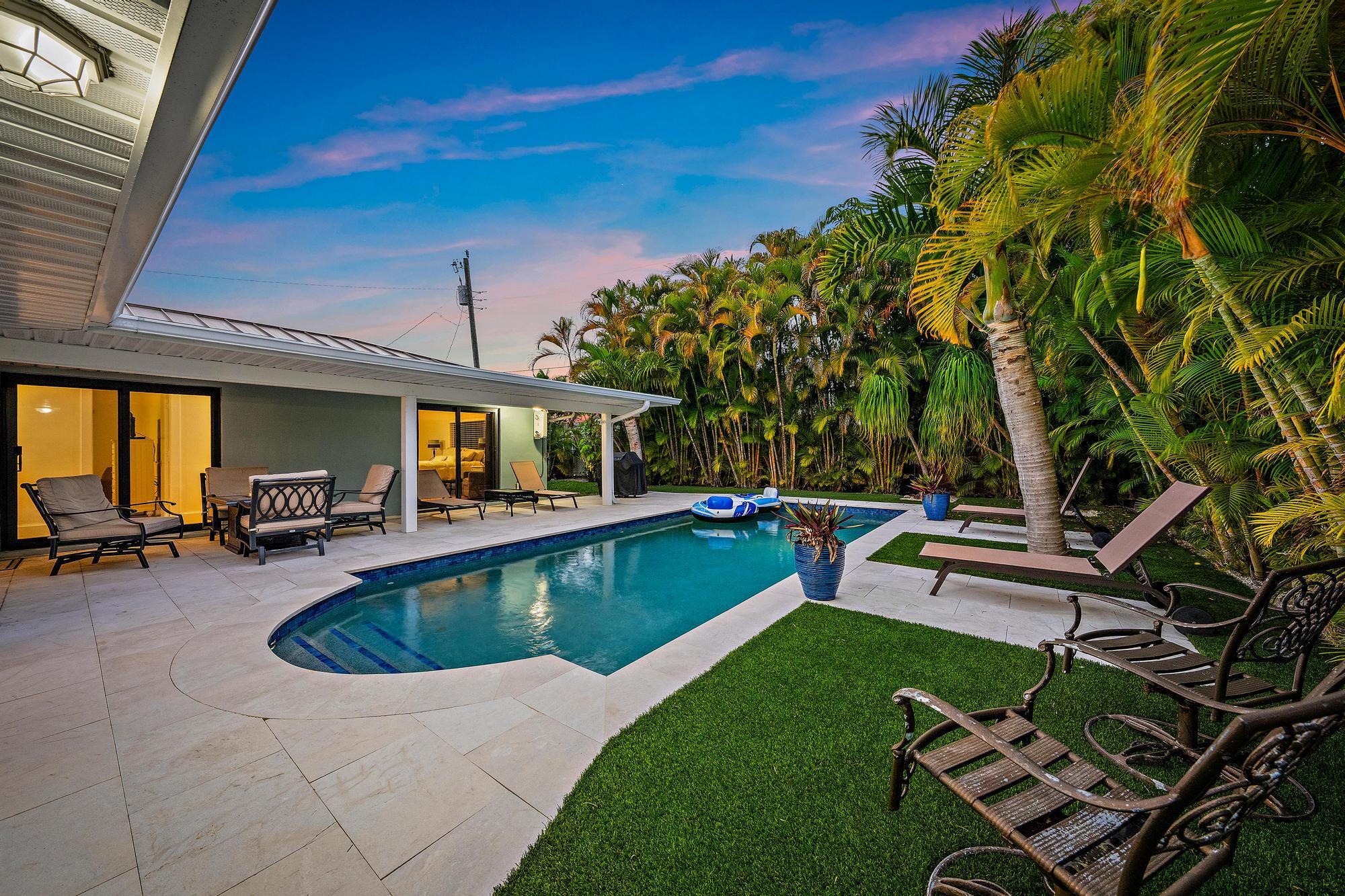 1120 Singer Drive Riviera Beach, FL 33404 - Photo 22 of 37 a view of a house with swimming pool and sitting area