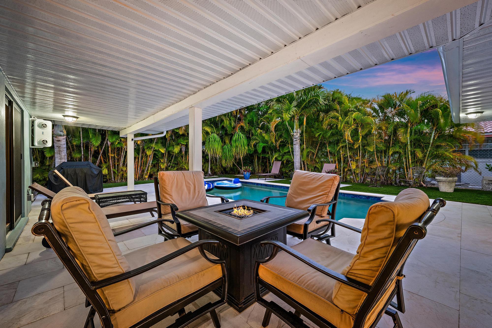 1120 Singer Drive Riviera Beach, FL 33404 - Photo 3 of 37 a view of a patio with a table chairs and a backyard