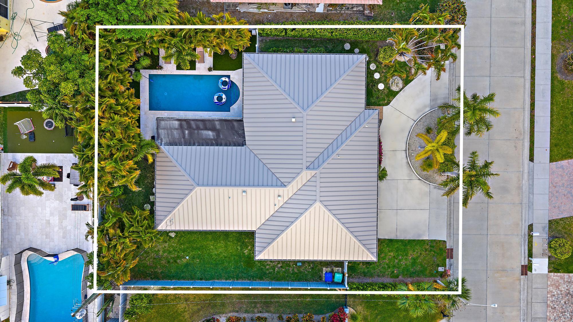 1120 Singer Drive Riviera Beach, FL 33404 - Photo 31 of 37 an aerial view of house with yard swimming pool and outdoor seating