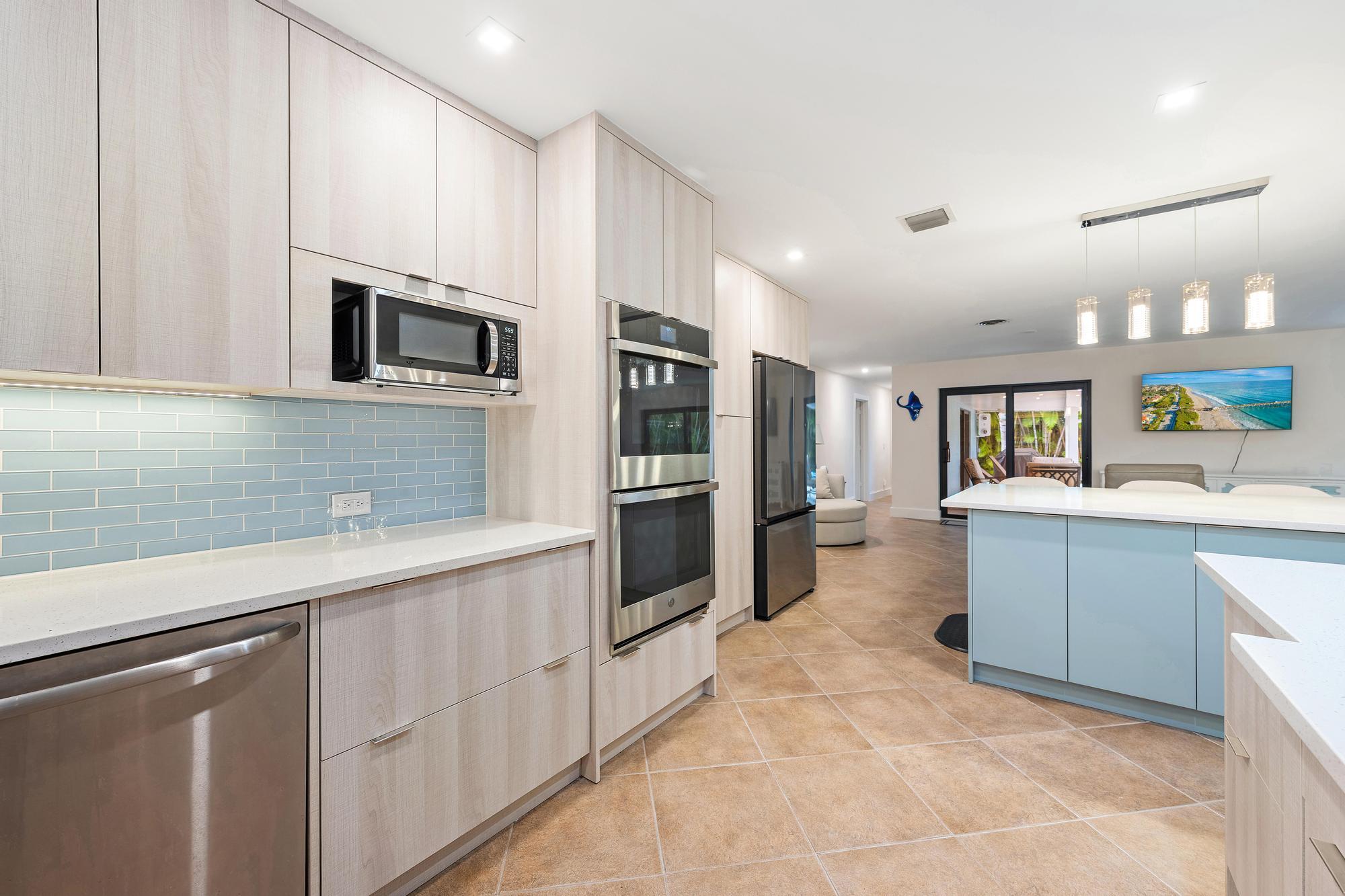 1120 Singer Drive Riviera Beach, FL 33404 - Photo 7 of 37 a kitchen with cabinets and oven