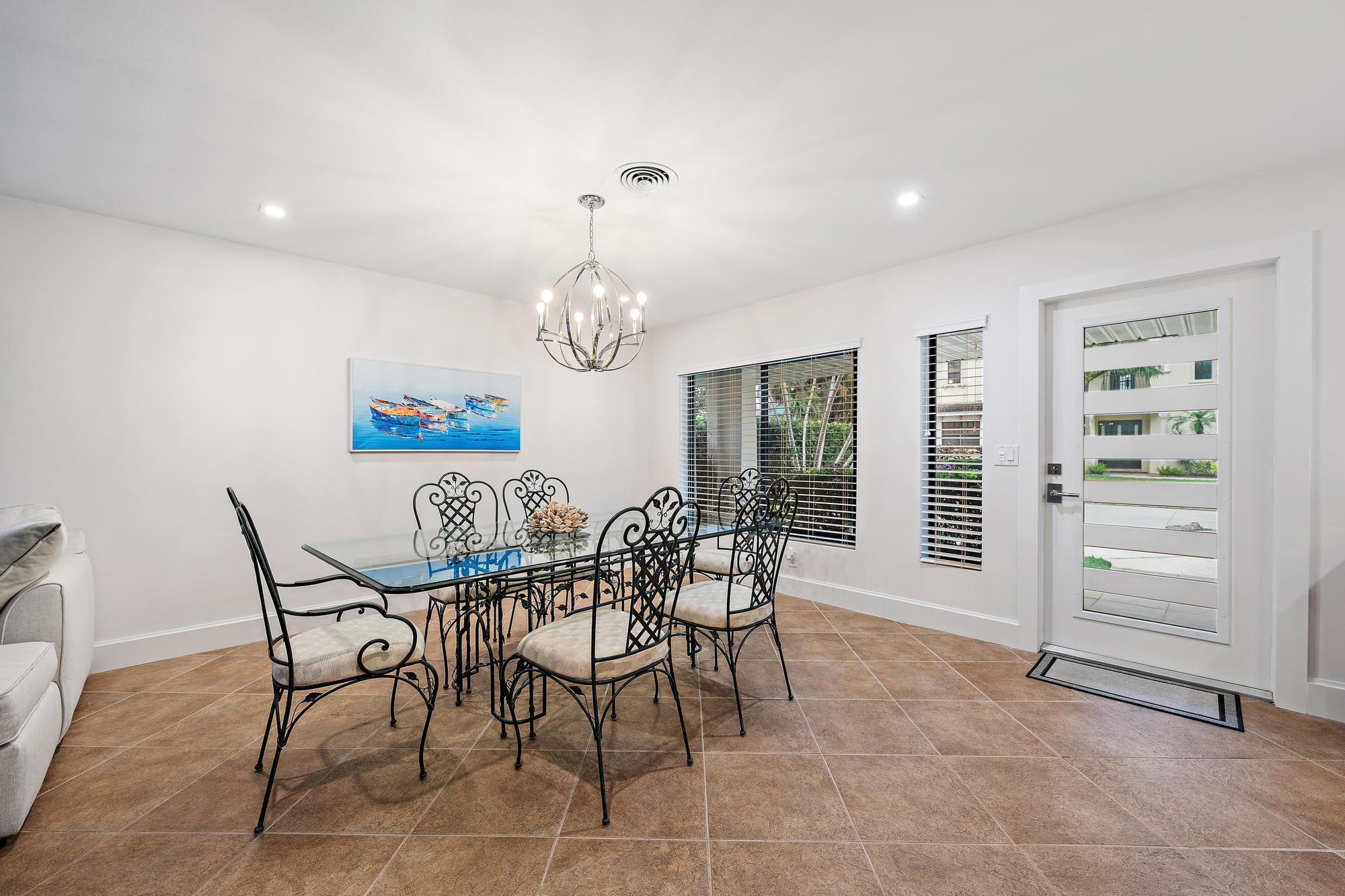 1120 Singer Drive Riviera Beach, FL 33404 - Photo 8 of 37 a view of a dining room with furniture window and outside view